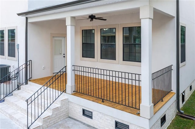 doorway to property featuring central air condition unit, stucco siding, and a ceiling fan