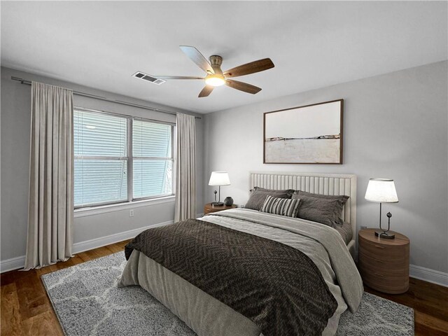 bedroom featuring ceiling fan and dark hardwood / wood-style floors