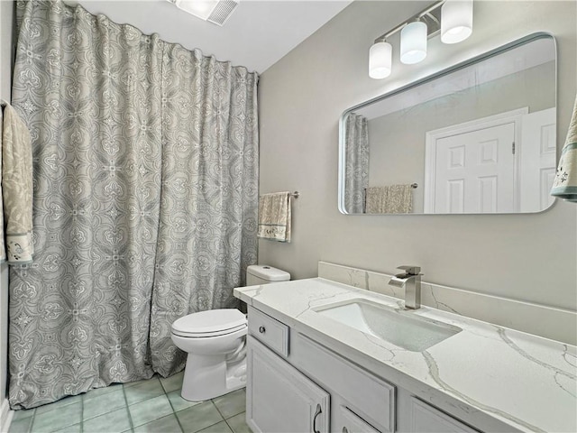 bathroom featuring vanity, tile patterned flooring, and toilet