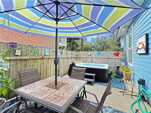 deck featuring a hot tub and central AC