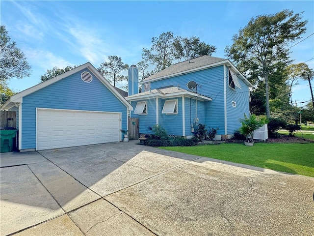 view of front of property with a front yard, an outdoor structure, and a garage