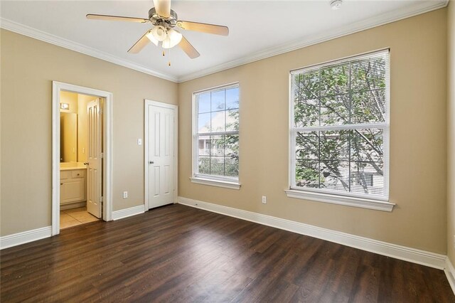 unfurnished bedroom featuring a closet, ornamental molding, connected bathroom, dark hardwood / wood-style floors, and ceiling fan