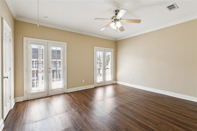 empty room featuring a wealth of natural light, french doors, and dark hardwood / wood-style flooring