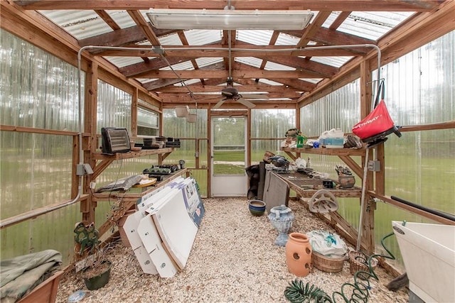 sunroom featuring ceiling fan and vaulted ceiling with beams