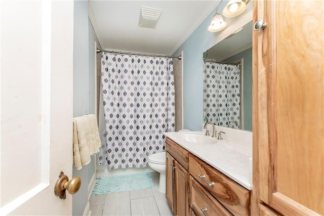 bathroom featuring ornamental molding, vanity, tile patterned floors, and toilet