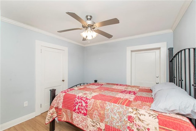 bedroom with hardwood / wood-style floors, ceiling fan, and ornamental molding