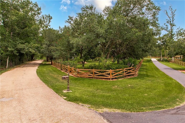 view of property's community with a yard