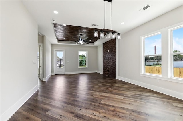 unfurnished dining area featuring dark wood-type flooring and ceiling fan