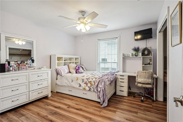 bedroom featuring light wood finished floors and ceiling fan