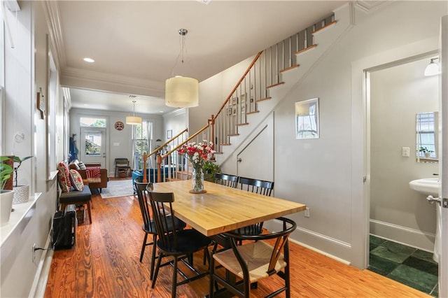 dining area featuring hardwood / wood-style floors and crown molding