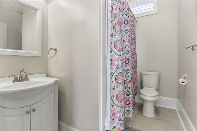 bathroom with vanity, curtained shower, tile patterned floors, and toilet