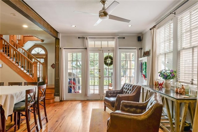 sitting room featuring light hardwood / wood-style flooring, crown molding, ceiling fan, and plenty of natural light