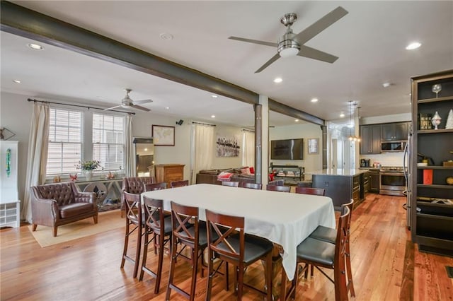 dining area with light hardwood / wood-style flooring and ceiling fan