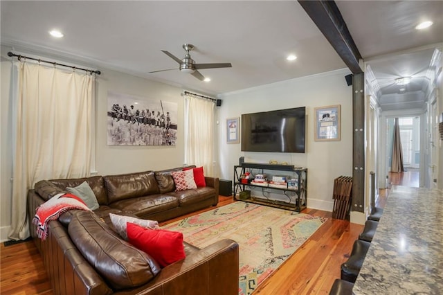 living room with wood-type flooring, beamed ceiling, crown molding, and ceiling fan