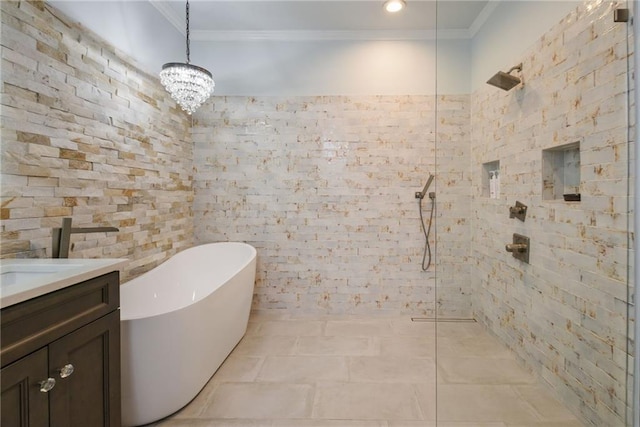 bathroom featuring shower with separate bathtub, an inviting chandelier, tile patterned flooring, ornamental molding, and vanity