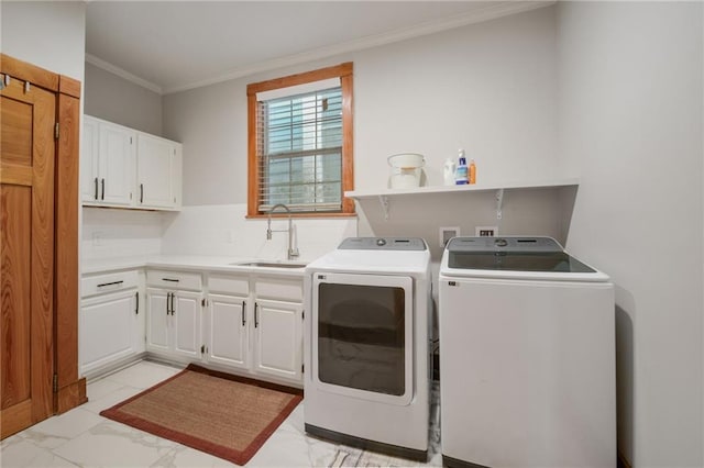 clothes washing area with cabinets, sink, washing machine and clothes dryer, and crown molding