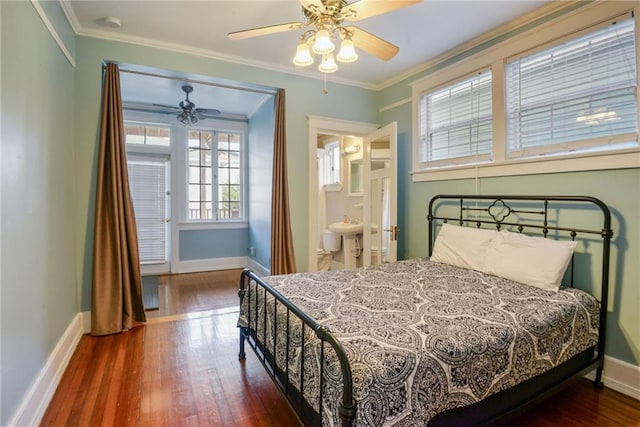 bedroom featuring ornamental molding, ensuite bathroom, dark wood-type flooring, and ceiling fan