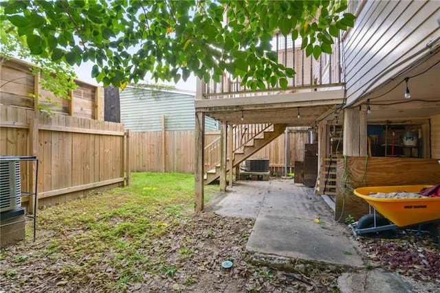 view of yard with central AC unit and a patio