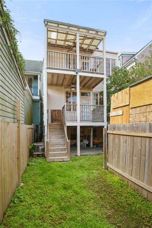 rear view of property featuring a yard and a deck