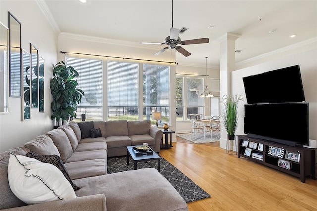 living room with ceiling fan, hardwood / wood-style floors, and ornamental molding