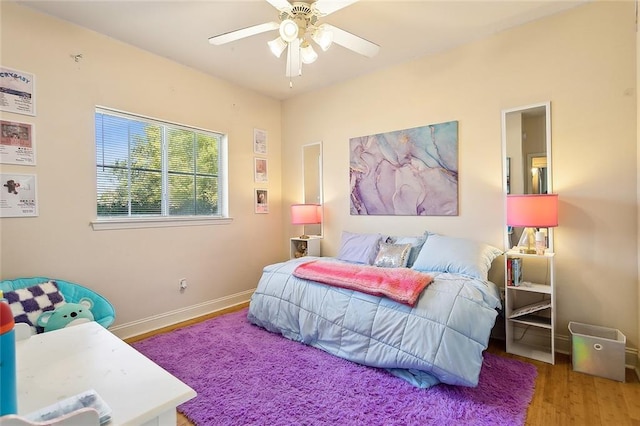 bedroom with ceiling fan and hardwood / wood-style floors