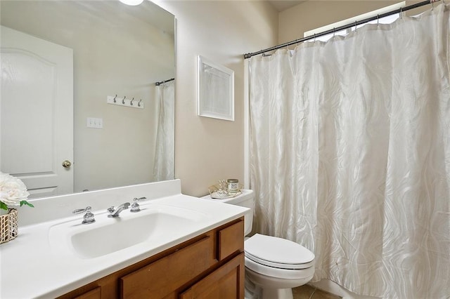 bathroom with tile patterned floors, vanity, and toilet