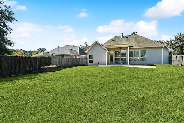 back of property featuring a yard and a patio