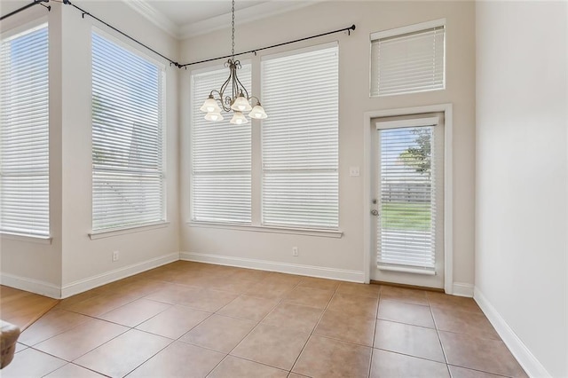 unfurnished dining area with an inviting chandelier, light tile patterned floors, and ornamental molding