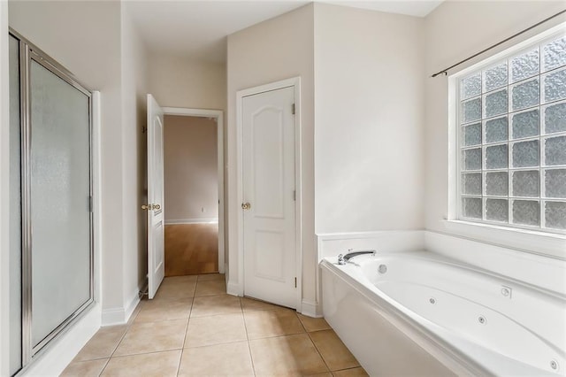 bathroom featuring tile patterned floors and separate shower and tub