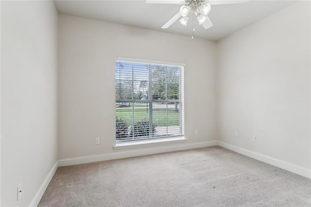 carpeted spare room with ceiling fan