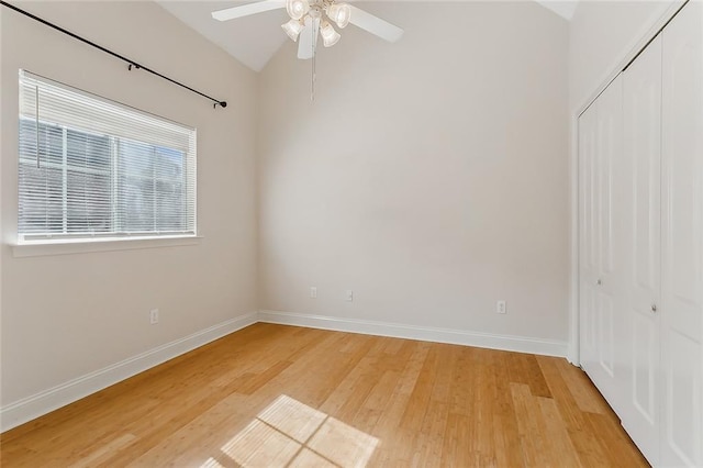 spare room featuring wood-type flooring, vaulted ceiling, and ceiling fan