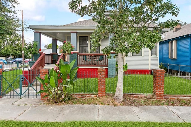 view of front of home featuring covered porch and a front yard