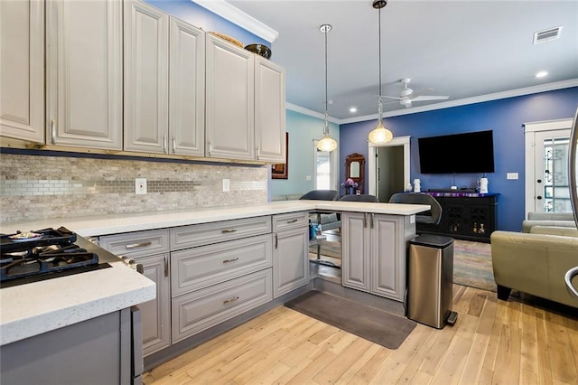 kitchen featuring a wealth of natural light, light hardwood / wood-style flooring, and gray cabinets