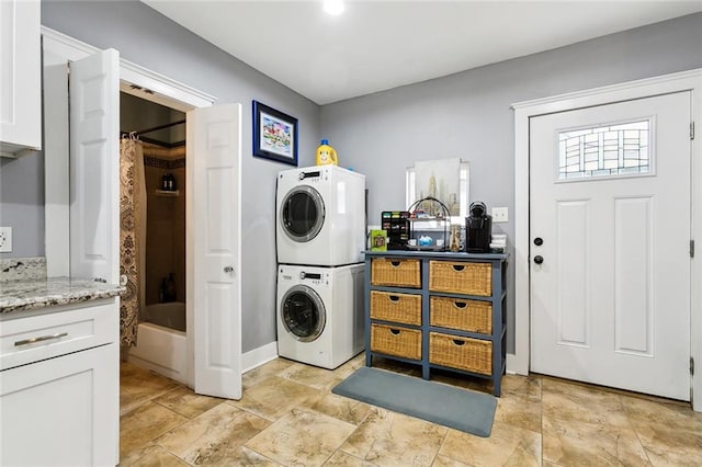 laundry room with stacked washer / dryer