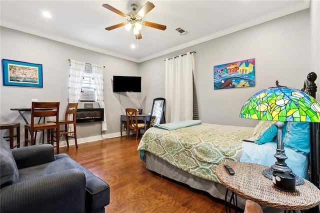 bedroom featuring ornamental molding, cooling unit, dark wood-type flooring, and ceiling fan