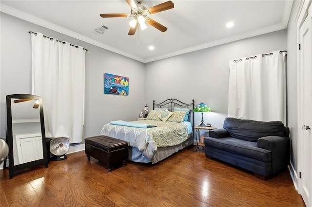 bedroom featuring ceiling fan, ornamental molding, and wood-type flooring