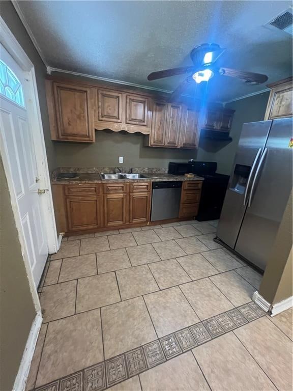 kitchen featuring stainless steel appliances, light tile patterned flooring, crown molding, and ceiling fan