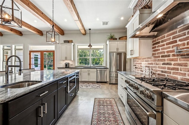 kitchen featuring pendant lighting, stainless steel appliances, a healthy amount of sunlight, and sink