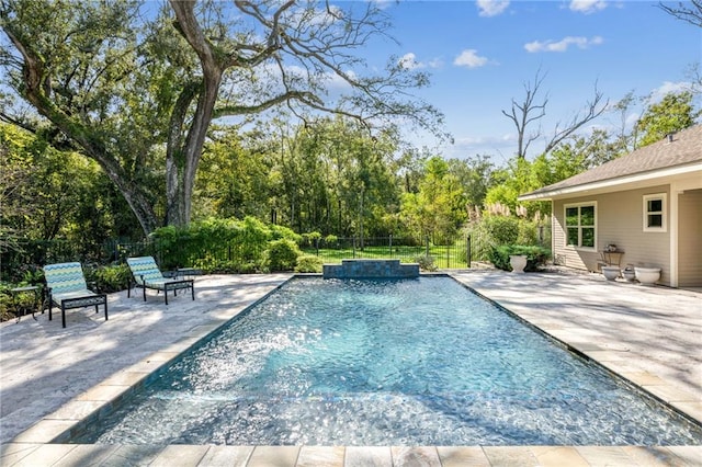 view of pool with pool water feature and a patio area