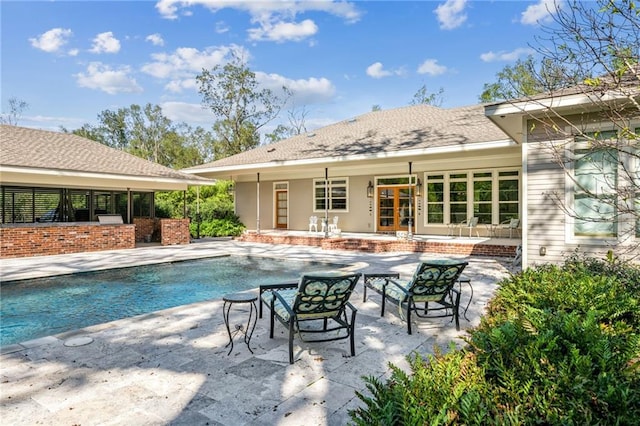 view of pool featuring a patio area and french doors