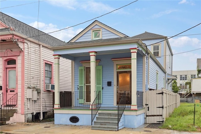 bungalow featuring covered porch and cooling unit