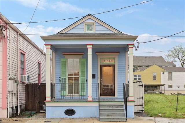 view of front of home featuring cooling unit and covered porch