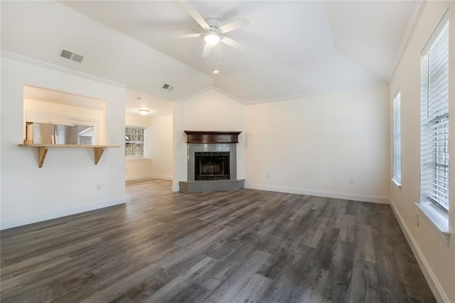 unfurnished living room with dark hardwood / wood-style flooring, vaulted ceiling, ceiling fan, and crown molding