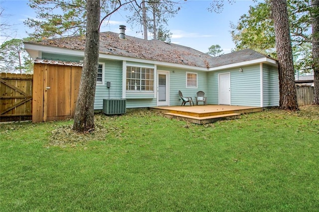 rear view of property featuring central AC, a yard, and a deck