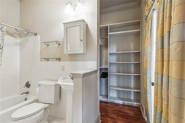 bathroom featuring crown molding, hardwood / wood-style floors, shower / bath combination with curtain, and toilet