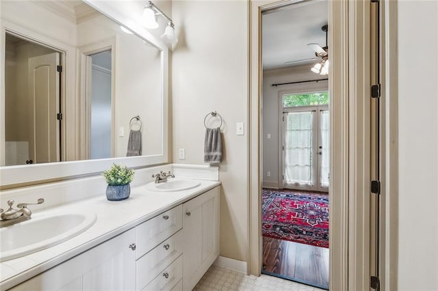 bathroom with tile patterned floors, vanity, ceiling fan, and ornamental molding