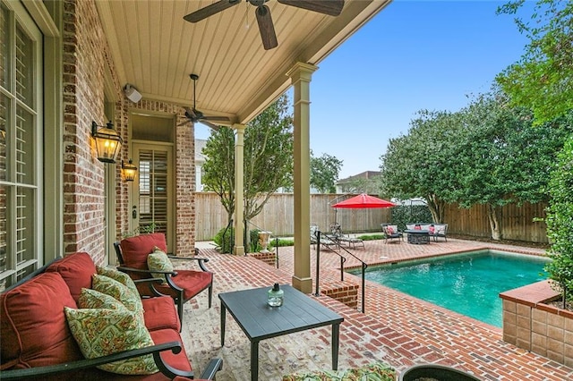 view of swimming pool featuring ceiling fan and a patio