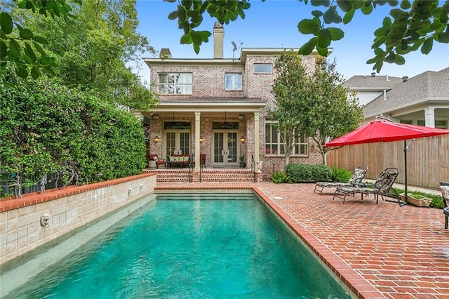 view of pool with a patio area and french doors