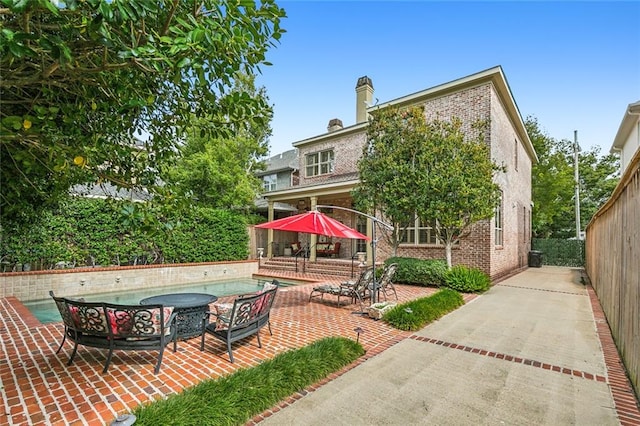 back of house with a patio