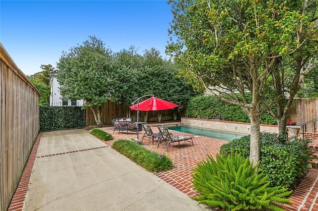 view of patio with a fenced in pool